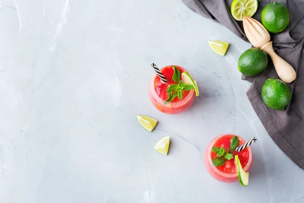 Food and drink, party holiday concept. Alcohol beverage cold cool red watermelon cocktail drink on a modern table for summer days. Top view flat lay background