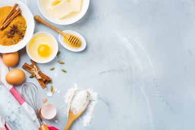 Pişirme malzemeleri ve aletleri mutfak masası üzerinde pişirme. Un, şeker, tereyağı, yumurta, baharat, tatlım. En iyi görünüm düz yatıyordu kopya alan arka plan