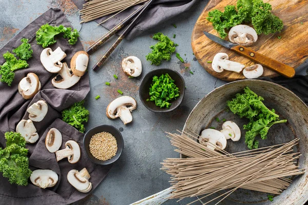 Buckwheat soba noodles soup ingredients for asian chinese japanese korean vietnamese food. Top view flat lay kitchen cooking background