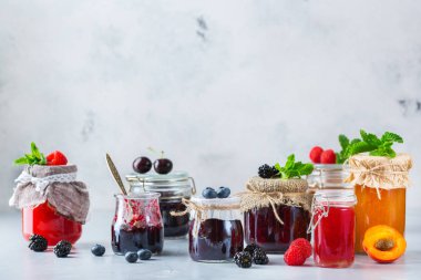 Yiyecek ve içecek, hasat yaz sonbahar kavramı. Kavanoz ahşap bir masa üzerinde mevsim meyveleri ve meyve sıkışmaları. Uzay rustik geçmiş Kopyala