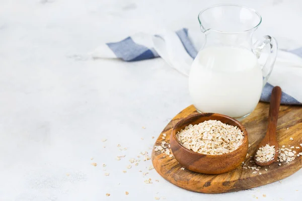 Food and drink, health care, diet and nutrition concept. Homemade organic vegan non diary oat milk on a kitchen table. Copy space background