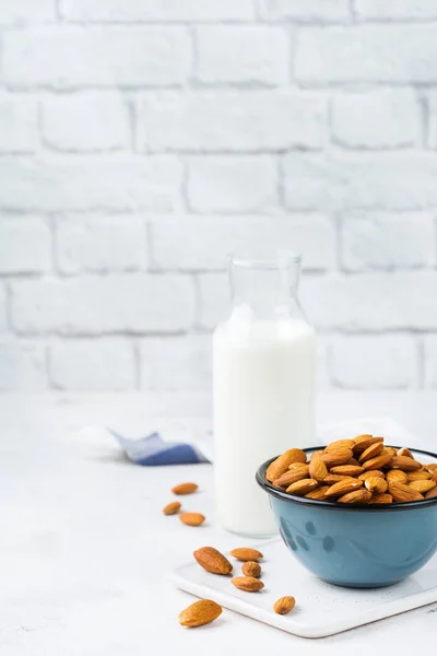 Food and drink, health care, diet and nutrition concept. Homemade organic vegan non diary almond milk on a kitchen table. Copy space background
