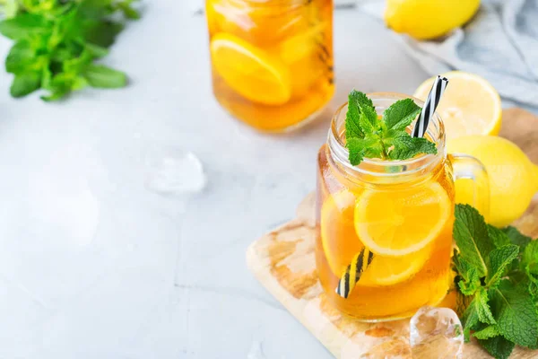 Food and drink, holidays party concept. Lemon mint iced tea cocktail refreshing drink beverage in a mason jar on a table for summer days. Copy space background