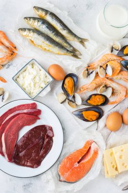 Dengeli beslenme, sağlıklı beslenme kavramı. Gıda kaynakları B12 vitamini açısından zengin, bir mutfak masasında kobalamin. Üst görünüm düz döşeme arka plan