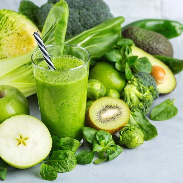 Food and drink, healthy dieting and nutrition, lifestyle, vegan, alkaline, vegetarian concept. Green smoothie with organic ingredients, vegetables on a modern kitchen table