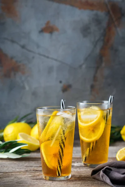 Food and drink, holidays party concept. Lemon mint iced tea cocktail refreshing drink beverage in a glass on a table for summer days. Copy space background