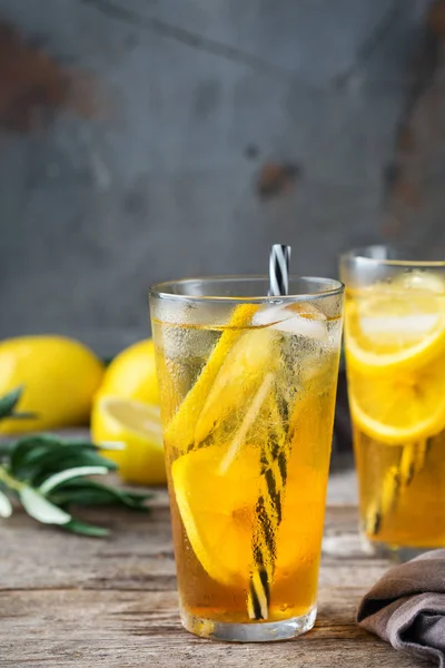 Food and drink, holidays party concept. Lemon mint iced tea cocktail refreshing drink beverage in a glass on a table for summer days