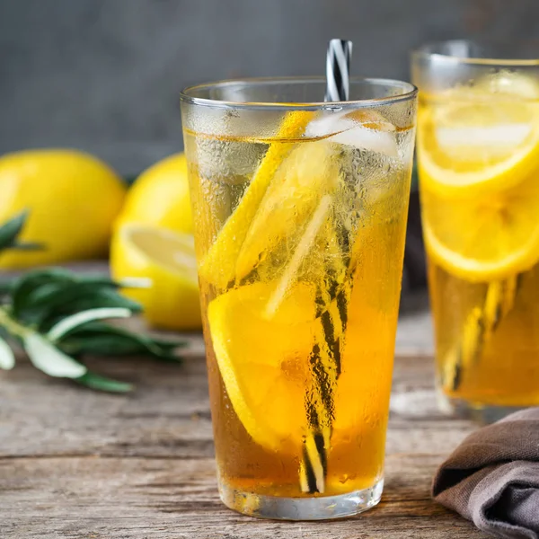 Food and drink, holidays party concept. Lemon mint iced tea cocktail refreshing drink beverage in a glass on a table for summer days