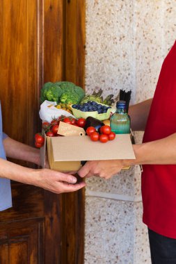 Zero waste no plastic home delivery service. Courier, man holding in hands box of food in recyclable and reusable, eco friendly package. Online internet order, shopping. Sustainable lifestyle concept clipart