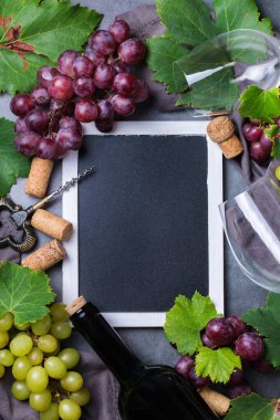 Yiyecek ve içecek, sonbahar hasat konsepti. Şarap tatma, içki içme, sembollü davetiye, üzüm asması, şişe, bardak, tirbuşon. Boşluk siyah arkaplanı kopyala