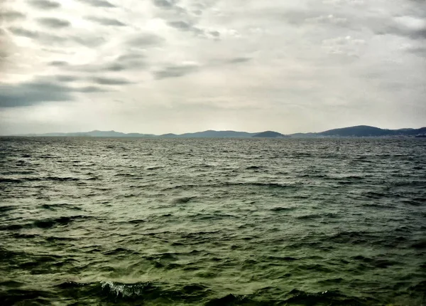 Stock image A cloudy day on the wavy sea