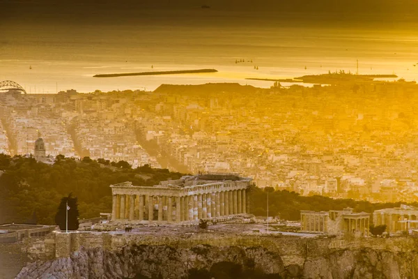 Acropolis of Athens, Greece, with the Parthenon Temple. Famous old Parthenon temple is the main landmark of Athens. View of Odeon of Herodes Atticus, Figures of the Caryatid Porch of the Erechtheion.