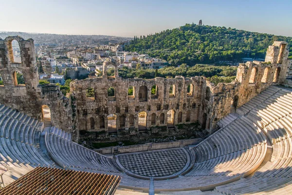 Acropolis of Athens, Greece, with the Parthenon Temple. Famous old Parthenon temple is the main landmark of Athens. View of Odeon of Herodes Atticus, Figures of the Caryatid Porch of the Erechtheion.