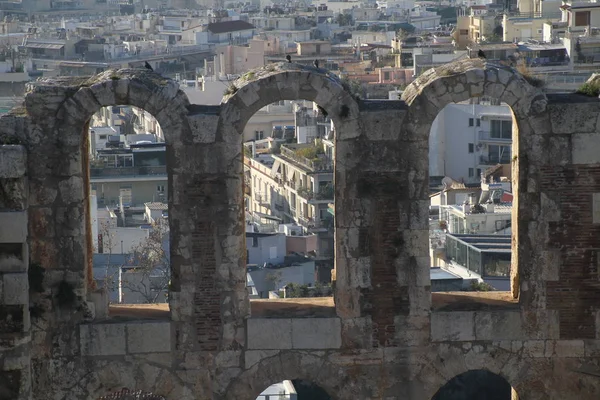 Acropolis of Athens, Greece, with the Parthenon Temple. Famous old Parthenon temple is the main landmark of Athens. View of Odeon of Herodes Atticus, Figures of the Caryatid Porch of the Erechtheion.