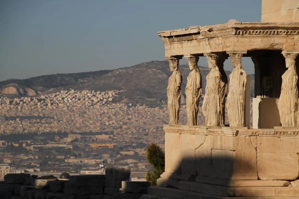 Acropolis of Athens, Greece, with the Parthenon Temple. Famous old Parthenon temple is the main landmark of Athens. View of Odeon of Herodes Atticus, Figures of the Caryatid Porch of the Erechtheion.