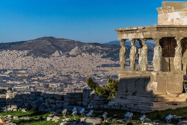 Acropolis of Athens, Greece, with the Parthenon Temple. Famous old Parthenon temple is the main landmark of Athens. View of Odeon of Herodes Atticus, Figures of the Caryatid Porch of the Erechtheion.