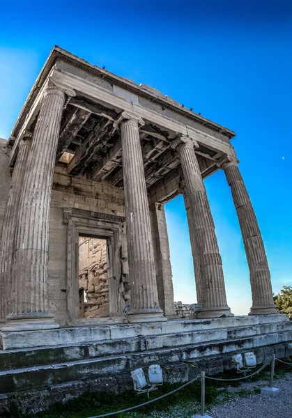 Acropolis of Athens, Greece, with the Parthenon Temple. Famous old Parthenon temple is the main landmark of Athens. View of Odeon of Herodes Atticus, Figures of the Caryatid Porch of the Erechtheion.