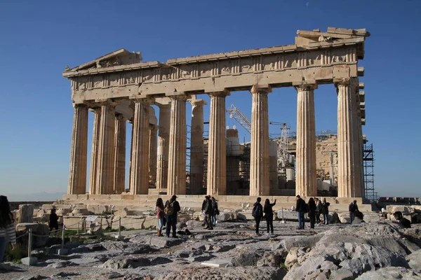 Acropolis of Athens, Greece, with the Parthenon Temple. Famous old Parthenon temple is the main landmark of Athens. View of Odeon of Herodes Atticus, Figures of the Caryatid Porch of the Erechtheion.