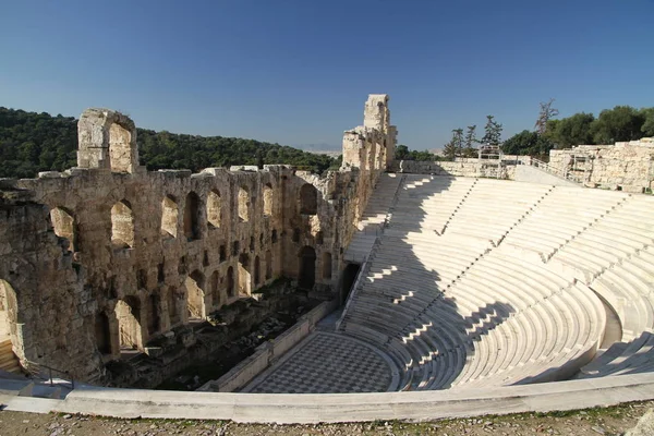 Acropolis of Athens, Greece, with the Parthenon Temple. Famous old Parthenon temple is the main landmark of Athens. View of Odeon of Herodes Atticus, Figures of the Caryatid Porch of the Erechtheion.