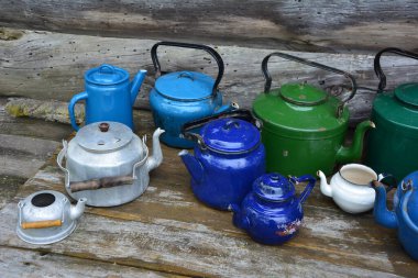 Eski çaydanlık koleksiyonu. Köhne çaydanlıklar kırsal alanda, eski demlerin arka planına karşı çekilir. Kırsal kesimlerde..