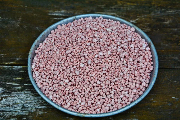 Mineral fertilizers granules.Mineral fertilizer with phosphorus in red. NPK fertilizers are three-component fertilizers providing nitrogen, phosphorus, and potassium