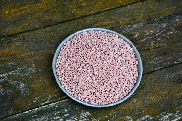 Mineral fertilizers granules.Mineral fertilizer with phosphorus in red. NPK fertilizers are three-component fertilizers providing nitrogen, phosphorus, and potassium