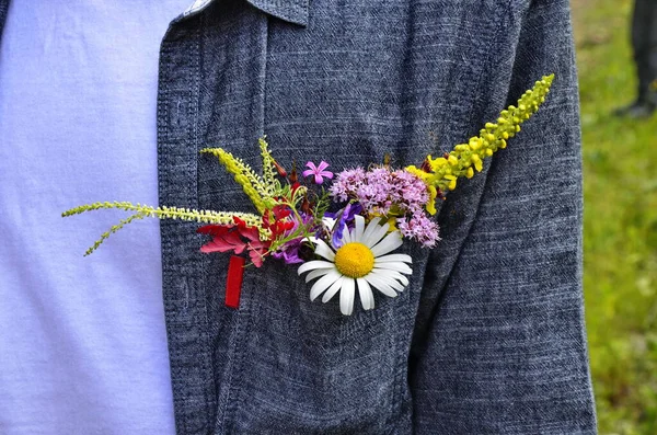 flowers in shirt pocket. Summer flowers in shirt pocket. Ecology concept.