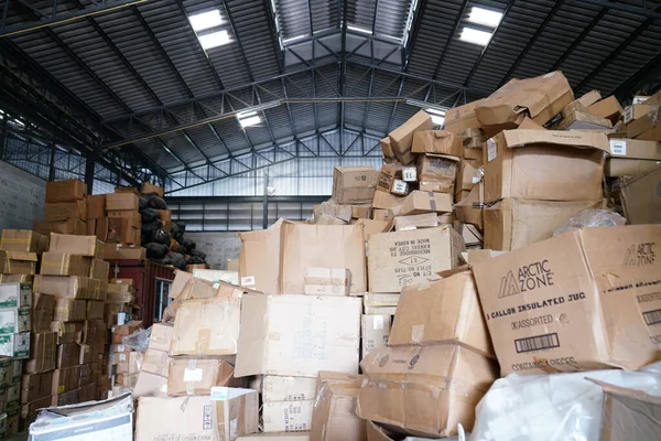 Blurry image of poorly organized warehouse with a lot of messy stocks and boxes