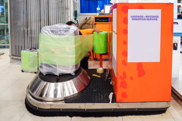 Luggage wrap machine service at the airport