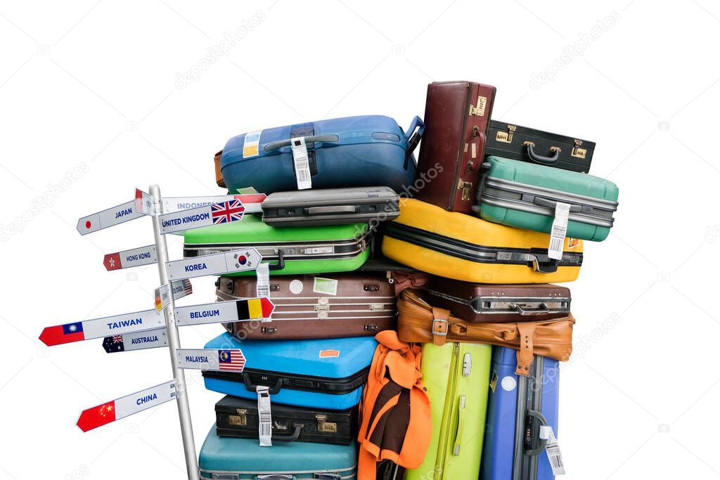 Travelling suitcases piled up with empty direction sign pole isolate on white