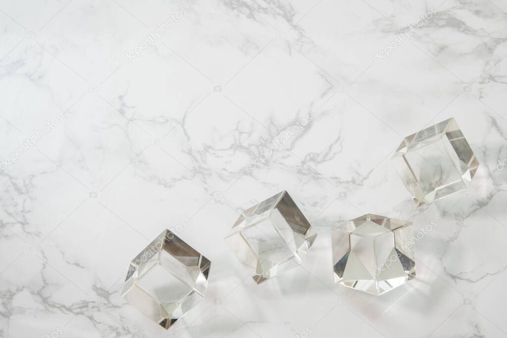 Crystal cubes on white marble background