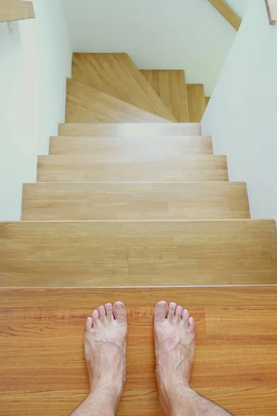 Man feet stepping down the stair