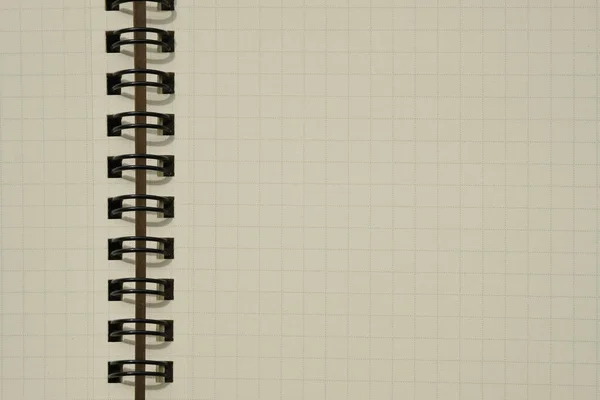 Closeup of coil binding notebook with empty blank page