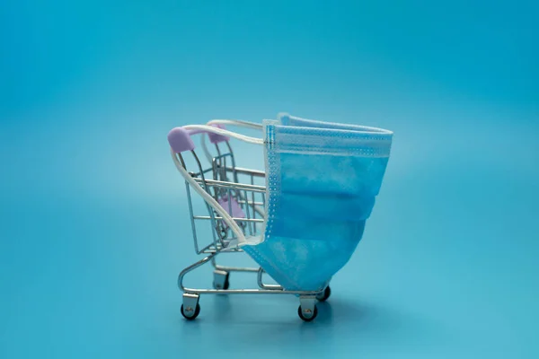 Shopping Trolley Wearing Blue Mask Blue Background — Stock Photo, Image