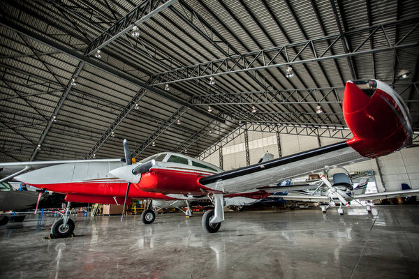 Private expensive aircraft in garage shot with wide angle lens