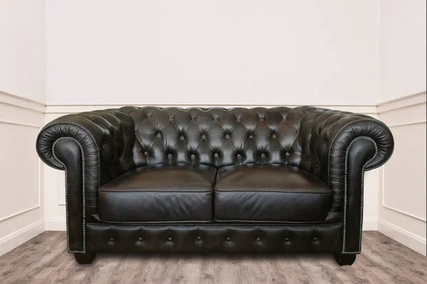 Leather sofa in a small cozy room clean and minimal