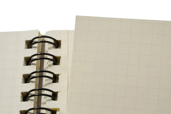 Closeup of coil binding notebook with empty blank page