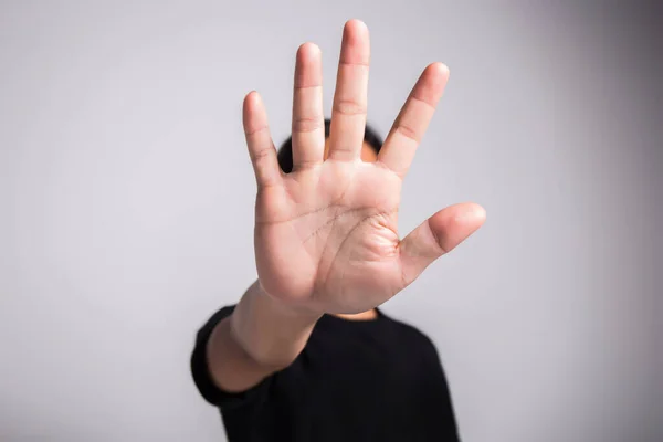 Hand of young man implying NO sign, rejecting expression or prevention