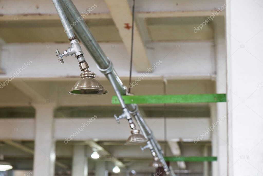 Shower from steel tube hanging from ceiling for prisoner in shower area of Alcatraz prison