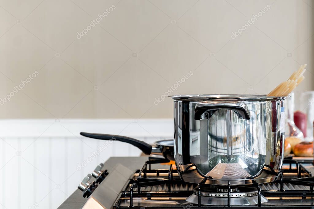 Stainless pot on stove in kitchen