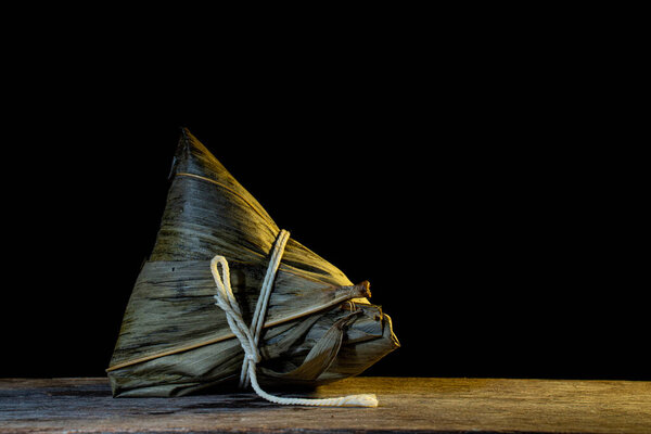 Zhuang, rice dumpling with fork and spoon in contrasty lighting