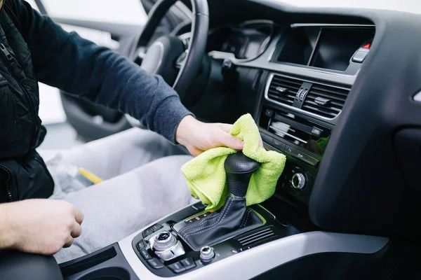 man cleaning car interior, car detailing (or valeting) concept.