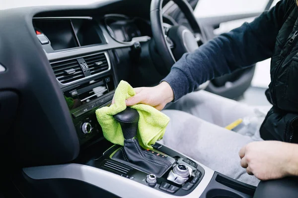 man cleaning car interior, car detailing (or valeting) concept.