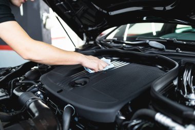 Bir adam mikrofiber bezle araba temizleme, araba temizleme (veya valelik) konsepti. Seçici odak. 