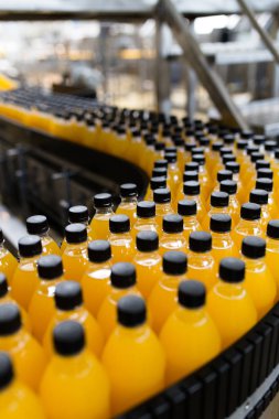 İçerideki sanayi fabrikaları ve makineler. Soda ve portakal suyu şişelerini işlemek ve şişelemek için robot fabrikası hattı.