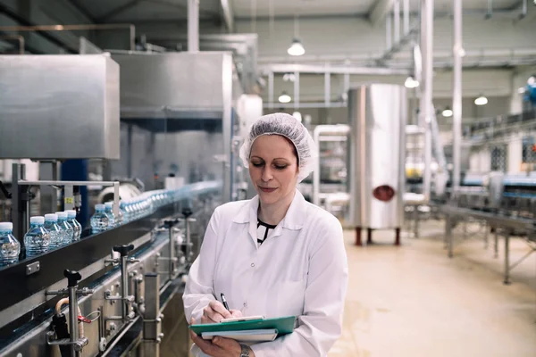 Jonge Gelukkig Werkneemster Fabriek Schrijven Van Nota Water Flessen Gallons — Stockfoto