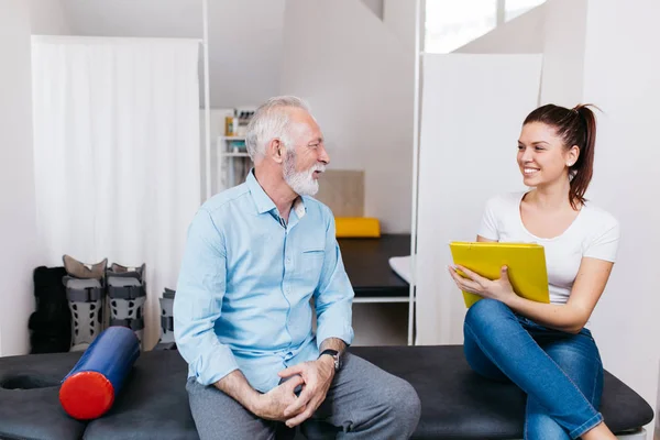 Senior Man Having Conversation Young Physical Therapist His Treatments — Stock Photo, Image