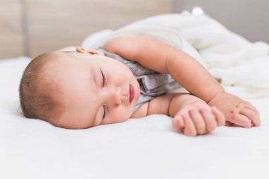 Güzel bebek çocuk yatakta uyuyan kaygısız.