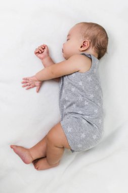 Güzel bebek çocuk yatakta uyuyan kaygısız.