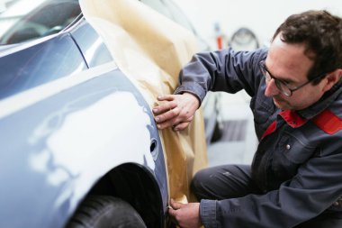 Car painting procedure at auto service store. clipart